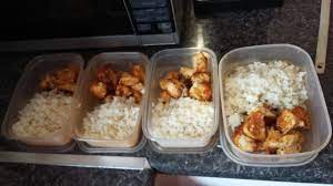Cooked chicken and rice in containers.